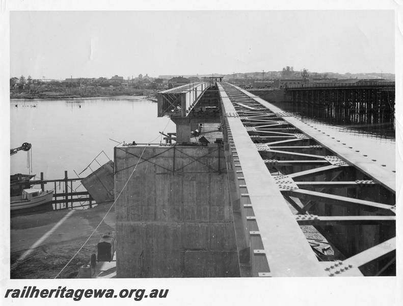 P00059
22 of 98 images showing views and aspects of the construction of the steel girder bridge with concrete pylons across the Swan River at North Fremantle.

