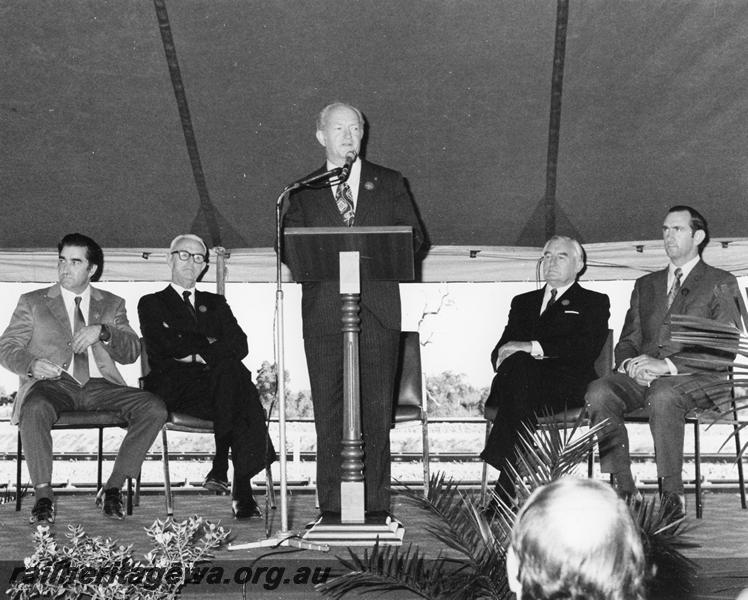 P00345
Ceremony for the opening of the Forrestfield, Commissioner of Railways, Mr. R. J. Pascoe at the microphone, the Premier, Mr. C. Court on the dais.
