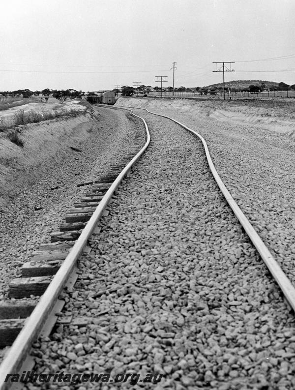 P00395
Track, distorted due to derailment of an iron ore train near Kellerberrin, view along the track,  date of the derailment 19/2/1974
