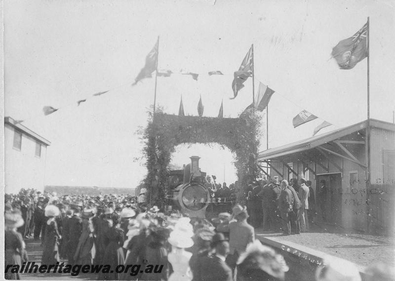 P00531
Unknown class of loco, station building, Sandstone, large crowd gathered to watch the train pass through an archway to mark the opening of the line, the line closed in 1949, same as P3567
