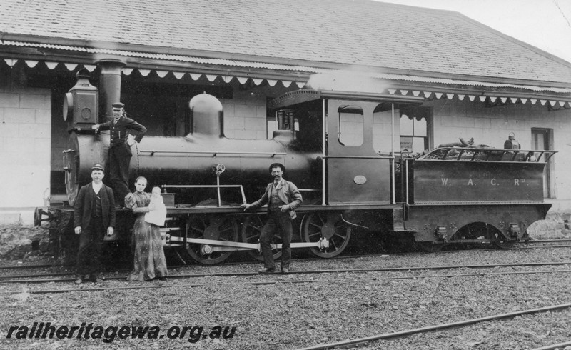 P01013
M class 2-6-0 at the original Northampton railway station, side view, staff and lady with a baby posing in front of the loco.

