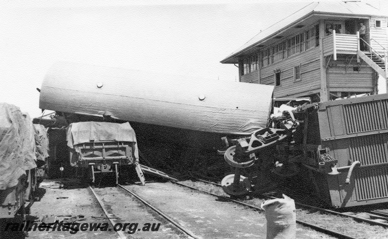 P01029
7 of 10 views of the derailment of A class 1501 at Northam Station, ER line. Van on top of other wagons, signal box. date of derailment 2/11/1961
