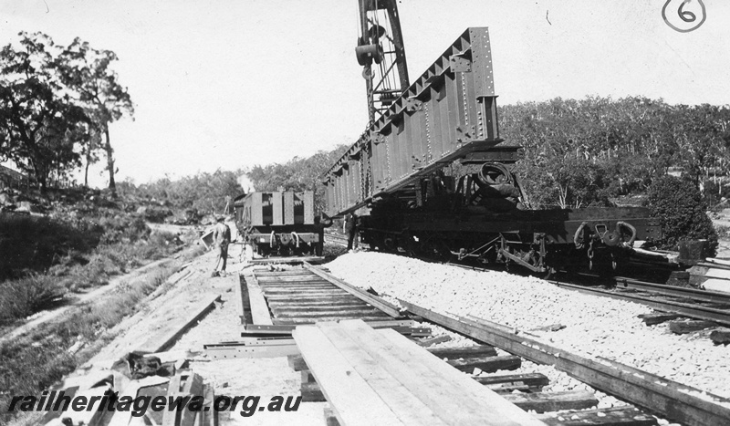 P01433
8 of 13 images of the construction of the duplicate steel girder bridge No.1 at 16 miles 25 chains on the ER through the John Forrest National Park, main girder being lifted into position.
