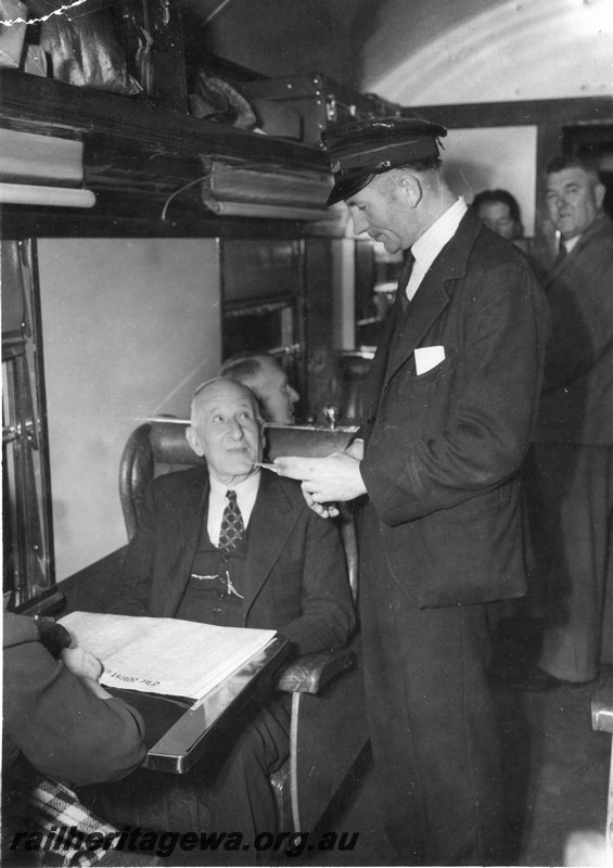 P01440
A conductor checks the ticket of a passenger on the 