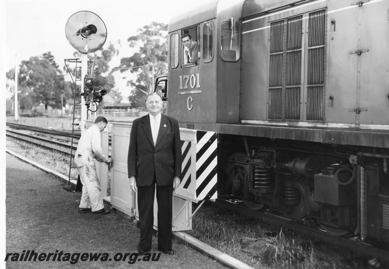 P01470
C class 1701, searchlight signal, relay box, lineside  telephone box, Commissioner of Railways, Mr. C. G. C. Wayne posing in front of the cab
