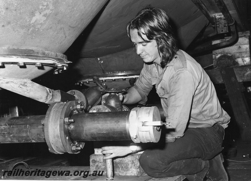 P01521
WAGR employee R. Outred, Midland Workshops, at work under a wagon

