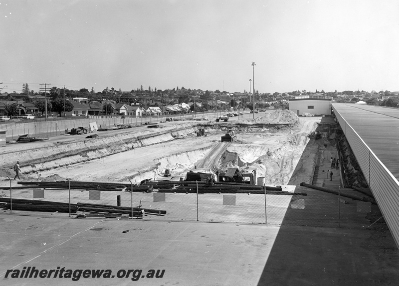 P01532
East Perth Terminal construction, progress view looking towards Mount Lawley, temporary terminal building in the background, aerial view, shows the Perth skyline
