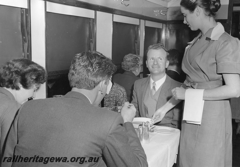 P01771
AV class Dining carriage, interior view showing a waitress serving passengers their meal
