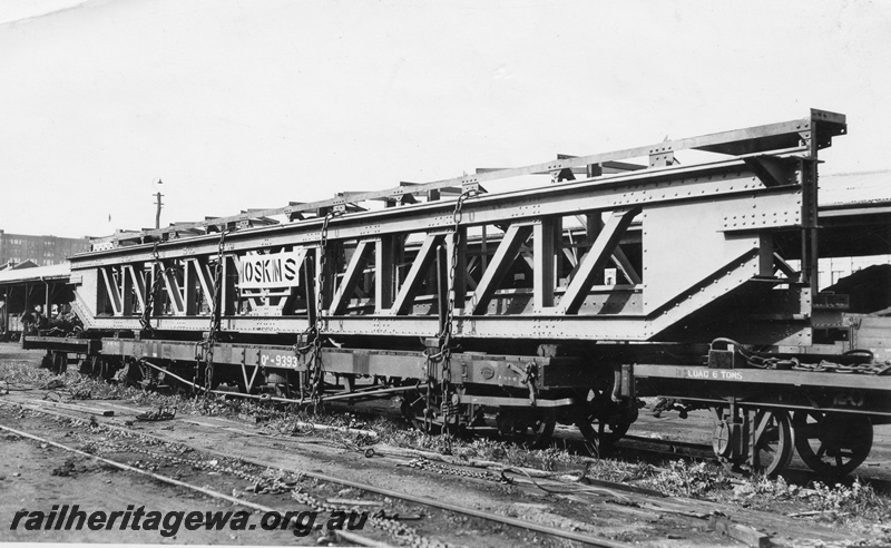 P01772
1 of 3 views of QA class 9393 bogie flat wagon carrying an over length electric crane traverser for the Great Boulder Mine, loaded at Perth Goods Yard, side and end view
