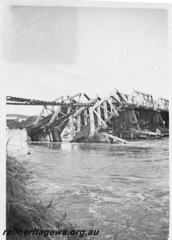 P01803
Collapsed bridge, North Fremantle, due to the 1926 flood, shows rails suspended and the collapsed trusses.
