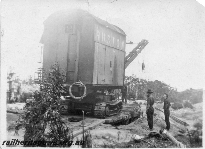 P02012
10 of 14. Ruston steam shovel being loaded onto a railway flat wagon with its bucket uncoupled from main boom cable, end and side view, construction of Denmark-Nornalup railway, D line.
