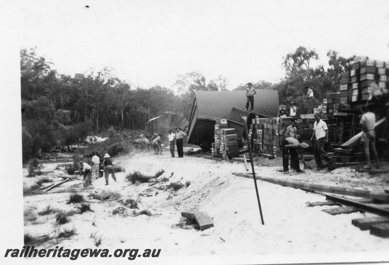 P02025
1 of 4 views of a derailment of No. 22 Fast Goods at the 157-78 mile point on the Donnybrook to Katanning Railway, DK line, between Noggerup and Goonac, van derailed, fruit cases stacked next to the track, date of derailment 26/3/1955
