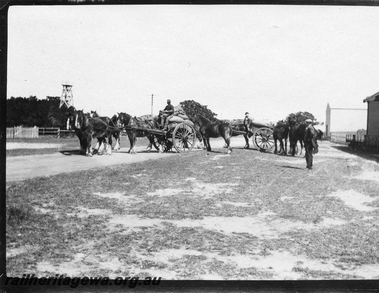 P02087
8 of 44 views of the construction of the railway at Esperance, CE line taken by Cedric Stewart, the resident WAGR engineer, horse and drays loaded with bags at the goods shed
