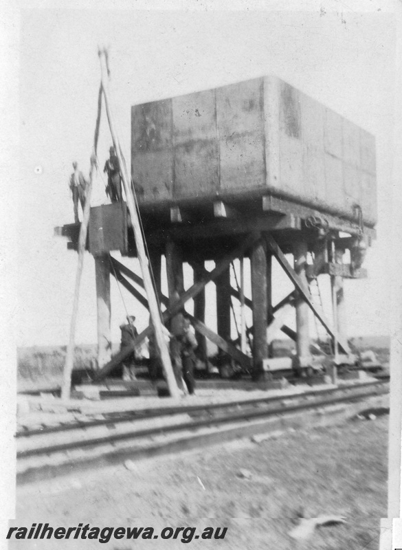 P02088
9 of 44 views of the construction of the railway at Esperance, CE line taken by Cedric Stewart, the resident WAGR engineer, construction of the 25,000 gallon cast iron  tank, water tower, panel being lifted into place.
