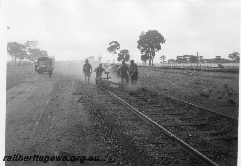 P02111
2 of 7 views of the early relaying of the track on the EGR, c1950, gangers operating a machine on the rails, view along the track
