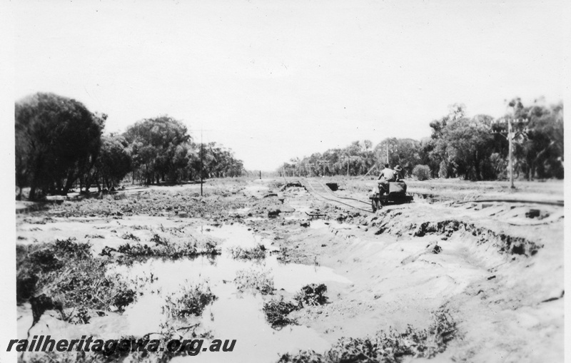 P02126
2 of 7 views of flooding and washaways on the Narrogin to Wagin section of the GSR, workers on a motorised gangers trolley on a section of track severely affected by the washaway
