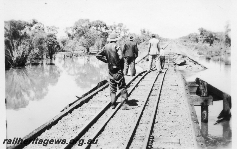 P02127
3 of 7 views of flooding and washaways on the Narrogin to Wagin section of the GSR, workers standing on a bridge with the approach washed away, view along the bridge
