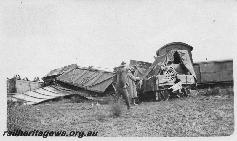 P02138
7 of 9 views of a derailment of No 26 Mixed on 26/6/1926 near Konnongorring, EM line, derailed and smashed wagons including D class 4153 with outside bracing and diagonal planking and H class 1916 with a motor vehicle on board
