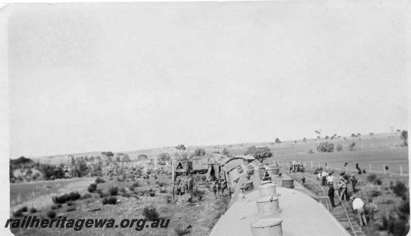 P02140
9 of 9 views of a derailment of No 26 Mixed on 26/6/1926 near Konnongorring, EM line, overall view of the site taken from the roof of a vehicle with oil lamps
