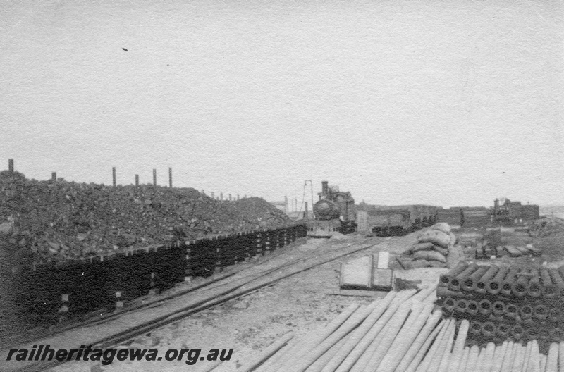 P02152
42 of 44 views of the construction of the railway at Esperance, CE line taken by Cedric Stewart, the resident WAGR engineer, coaling stage full of coal, G class loco in the background
