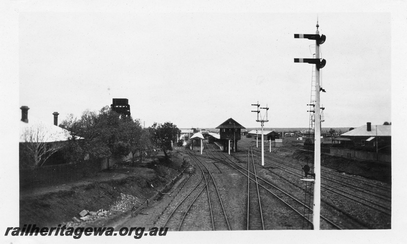 P02805
Signals, signal box, station buildings, 50,000 gallon water tower, Kalgoorlie, view looking west from Maritana Street Bridge
