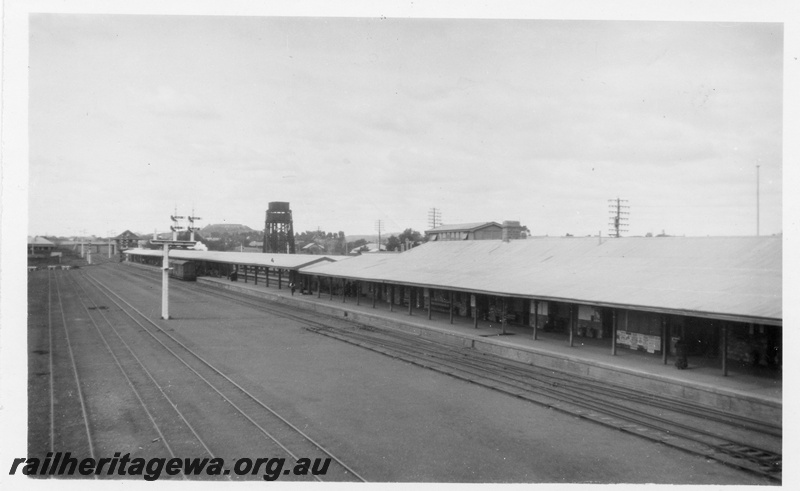 P02819
Kalgoorlie station looking east, station building, passenger platform, 55 ft. water tower with two 25,00 gallon cast iron tanks with one on top of the other, signal box in the background.
