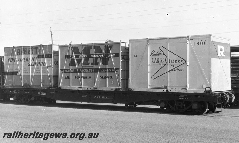 P02969
QU class 25008  flat top wagon  in the all over black livery loaded with an Ansett, a Mayne Nickless and a Rudders container, side view. Same as P0925
