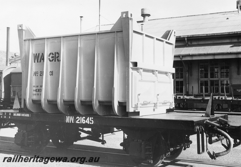 P02972
NW class 21645 flat wagon for iron ore containers loaded with a new container, side and end view.
