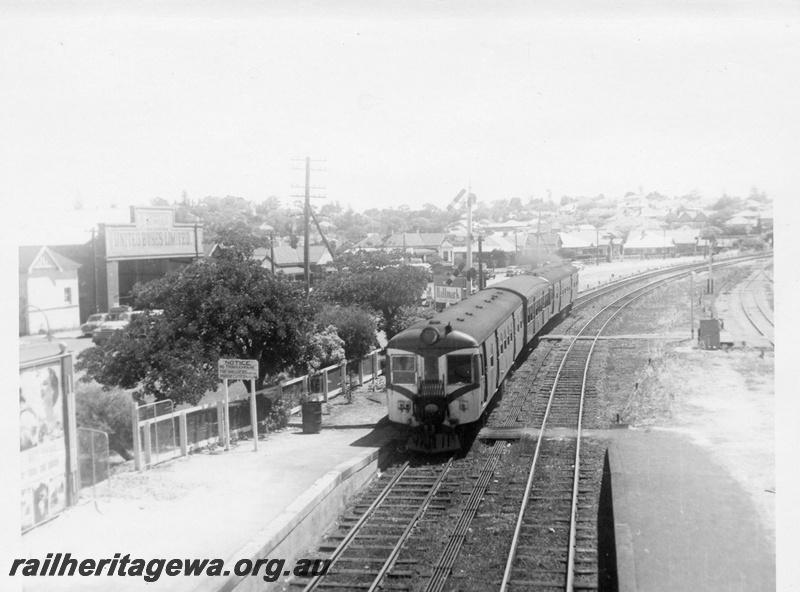 P03072
ADG class 614 and 617 diesel railcars and trailer, green livery with front painted white with re chevrons, tail disc, co-acting signal, point rodding, foot walks across the tracks,  passenger platform, siding, relay box, Claremont, ER line. United Buses Limited shed, in the background.
