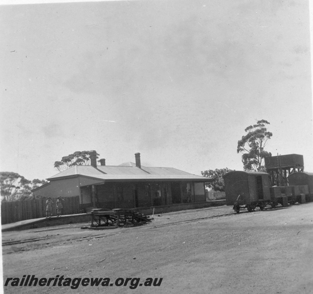 P03213
Station building, track side view, vans and wagons, soldiers on the platform, water tower, Moora, MR line, c1940s.
