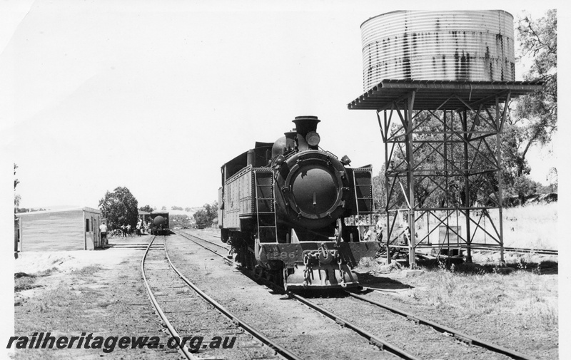 P03343
DM class 586 steam locomotive, front view, next to a steel framed water tower wiith a cylindrical corrugated iron tank, gangers shed, Gingin, MR line.
