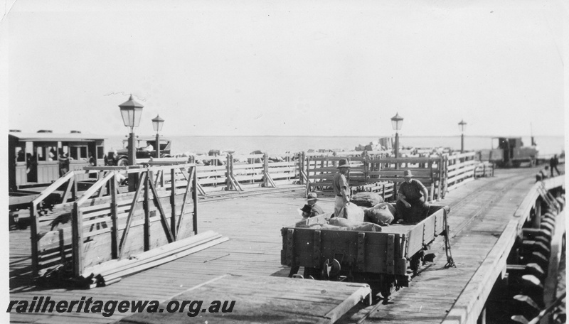 P03377
2 of 3 images of the jetty at Carnarvon, steam loco shunting the jetty, loaded wagons and carriage, open wagon being loaded, lamps

