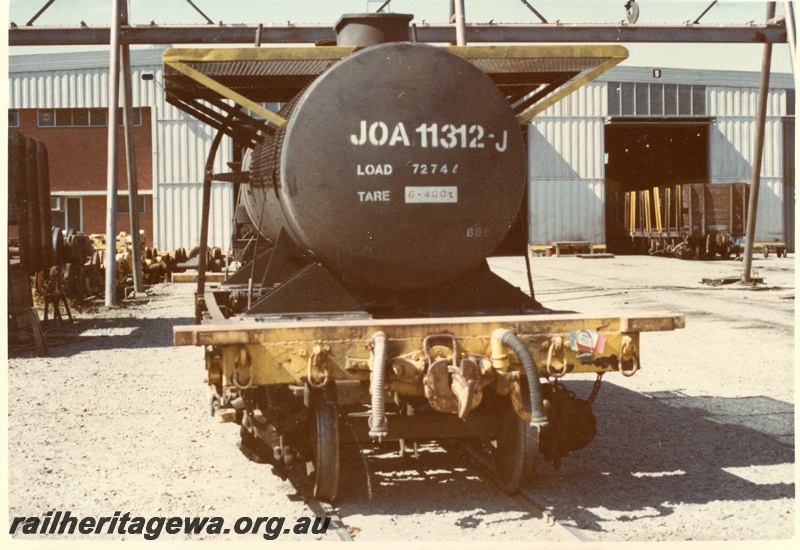P03621
JOA class 11312-J, mounted on a bogie wagon, end view
