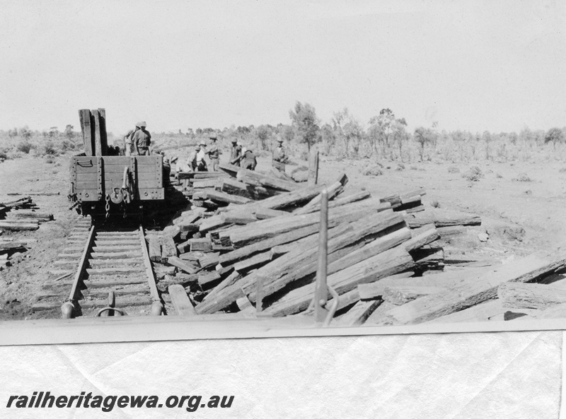 P03635
Pulling up the track on the Kalgoorlie to Kanowna railway, KK line, view along the track showing a wagon being loaded with sleepers and piles of sleepers adjacent to the track.
