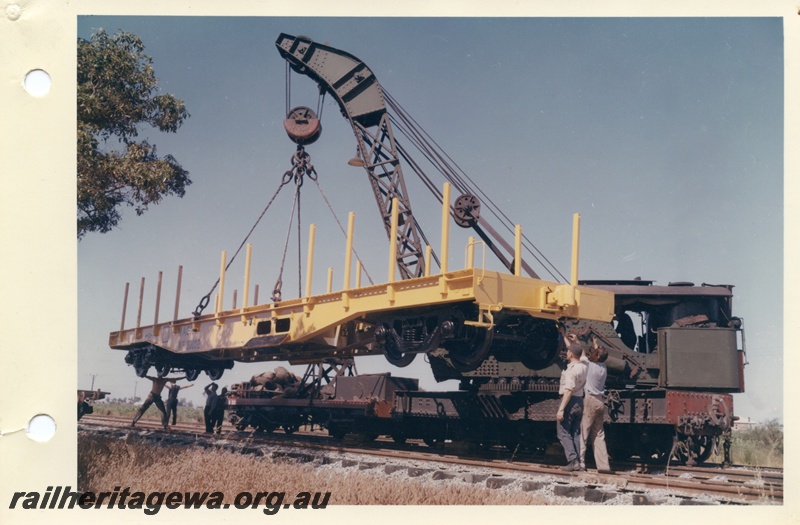 P03721
Cravens 25 ton breakdown crane No 23, lifting WSP flat top wagon, side and front view
