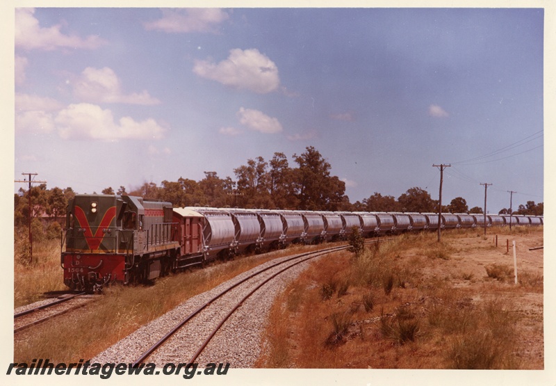 P03747
3 of 4, D class 1564 diesel locomotive hauling XF class alumina hoppers and brakevan, en route to Kwinana, front and side view.
