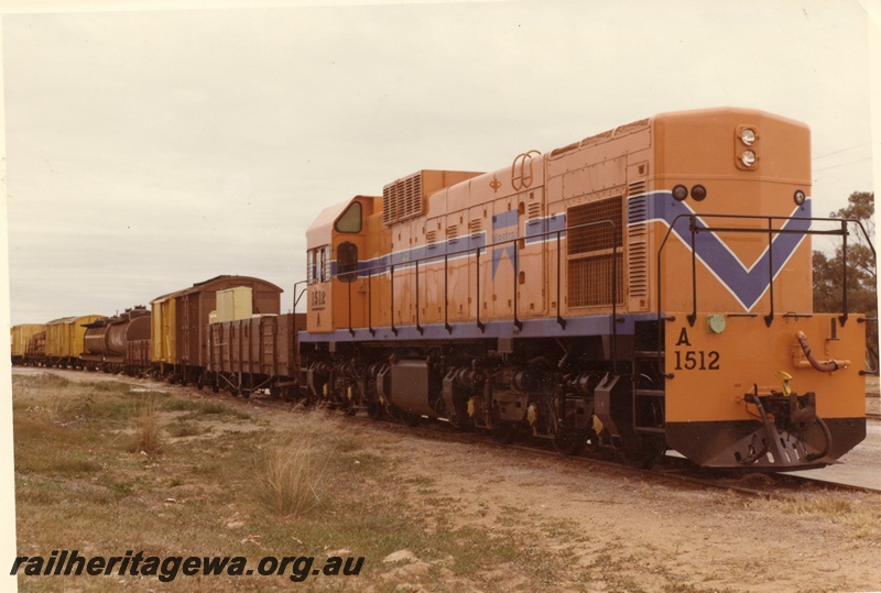 P03872
2 of 3, A class 1512 diesel locomotive on mixed goods train, side and front view, Westrail orange livery, on route to Geraldton.
