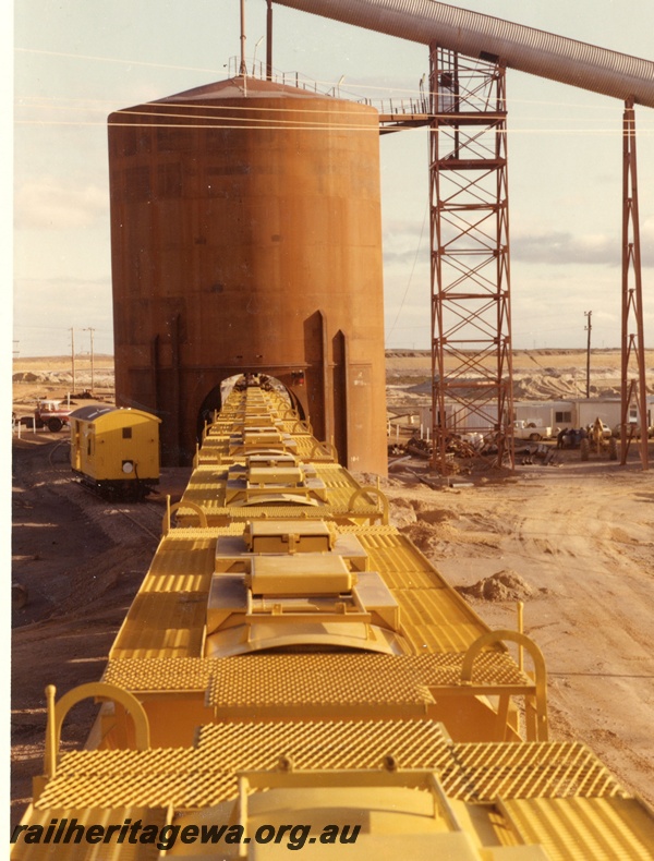 P03882
Elevated view of XE class bogie ilmenite hoppers at the train loader, Eneabba.

