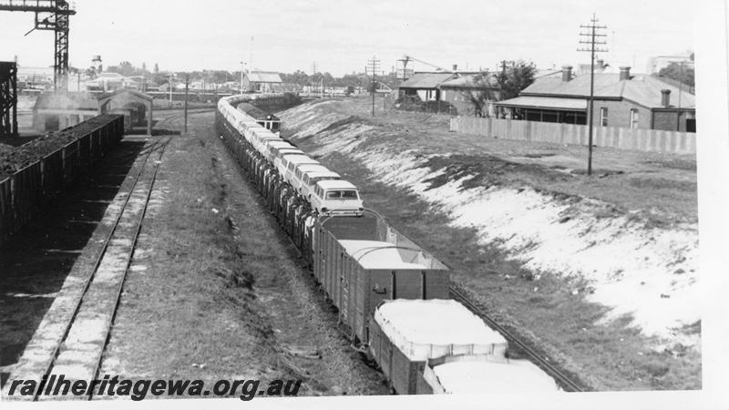 P06618
PMR class 725, East Perth, goods train, view towards front of train. Shows uncovered wheat in open wagons
