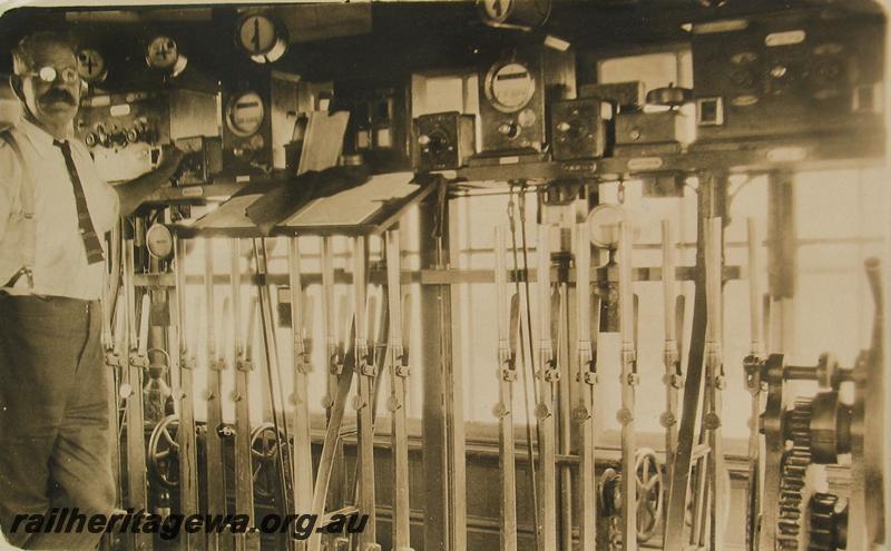 P07214
Signalman, internal view of signal box showing levers and instruments
