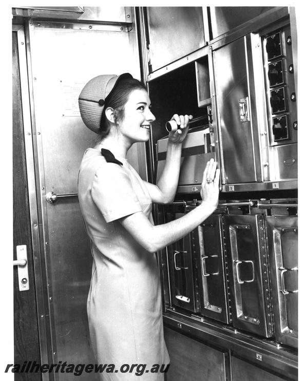 P07279
Hostess, galley, Prospector railcar, making an announcement on the public address system
