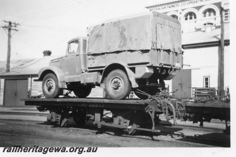 P07930
NF class 22857 flat wagon, small military vehicle on board, shows lashings, side and end view
