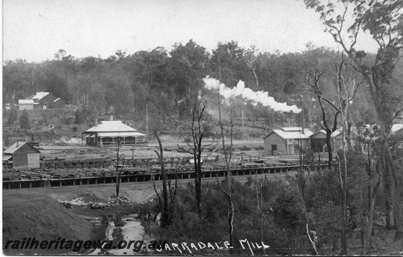 P07971
Mill, Jarrahdale, overall view, shows timber racks and substantial house in background, postcard.
