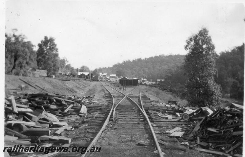P08257
Millars timber mill, Nanga Brook in the centre between the railway lines. Line from Yarloop is on the embankment on the left. First building on the left is the single men's quarters then the Mill Office, lines in the centre go down to a burnt our trestle bridge at Three Stringers..
