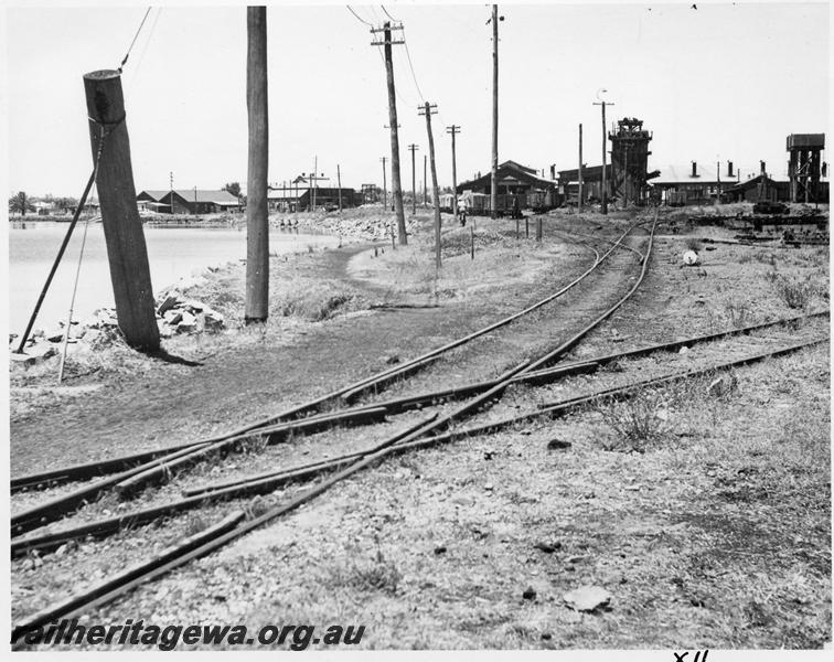 P08396
Trackwork featuring a diamond crossing leading into the Bunbury Loco Depot, shows the coaling stage, water tower, and roundhouse in the background.
