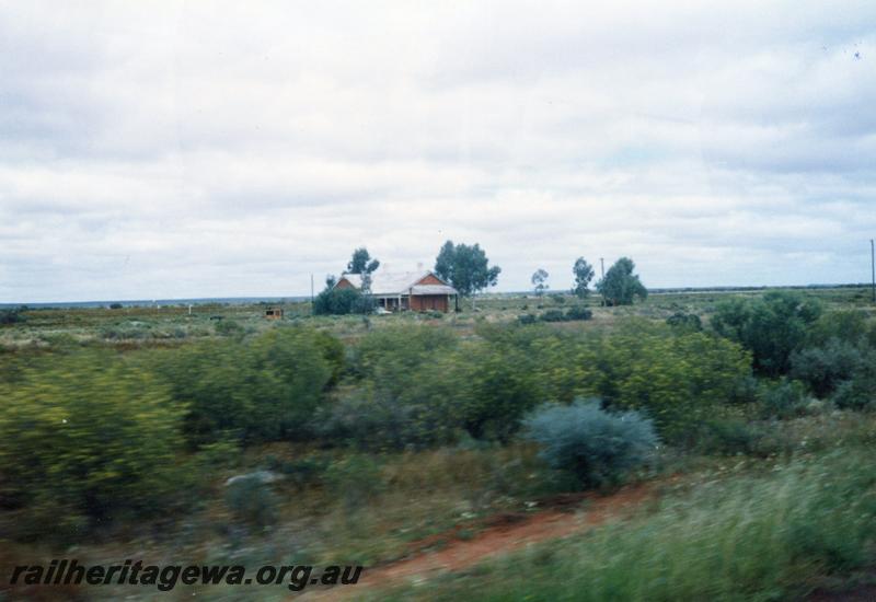 P08618
Yalgoo, barracks, distant view from road, NR line. View from moving vehicle.
