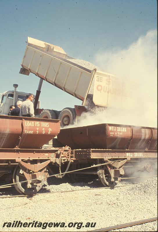 P09875
WSJ class 30586 ballast wagon, being loaded from road truck, wire rope for shunting. Forrestfield - Fremantle line.
