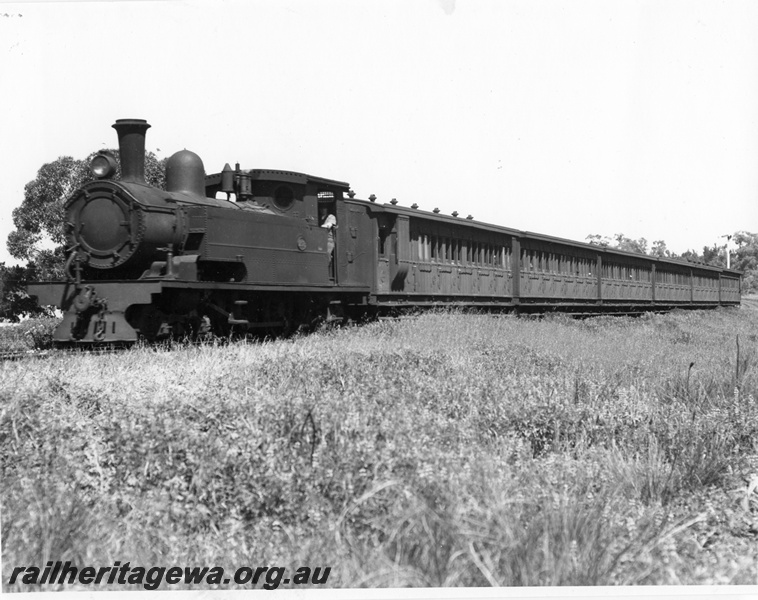 P10255
N class steam loco hauling a train of six low roof side loading suburban carriages, AD class carriage with guards compartment behind the loco. View along the train
