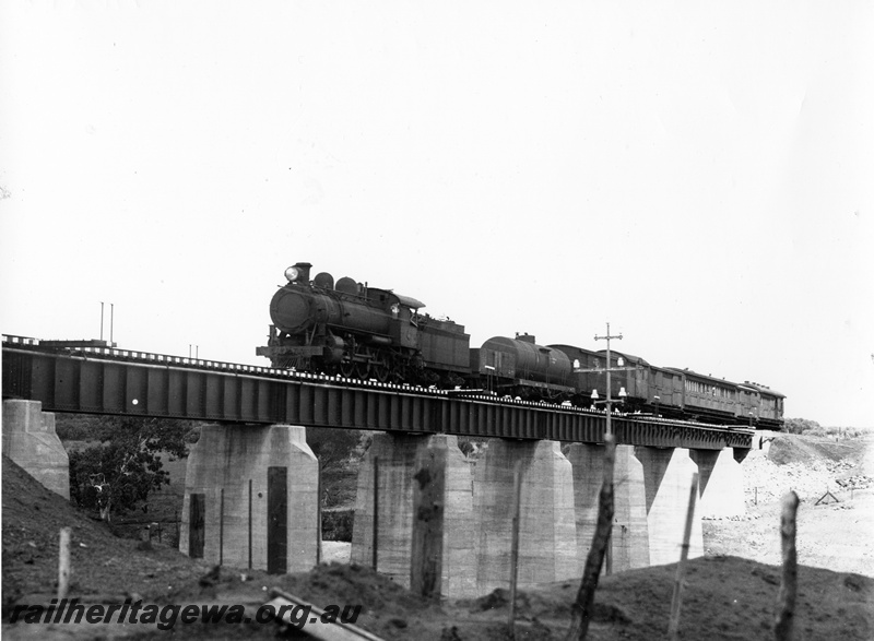 P10265
L class steam loco, steel girder bridge on concrete pylons, Eradu, NR line, on short mixed train, view of train on the bridge, same as P7833 but better quality.
