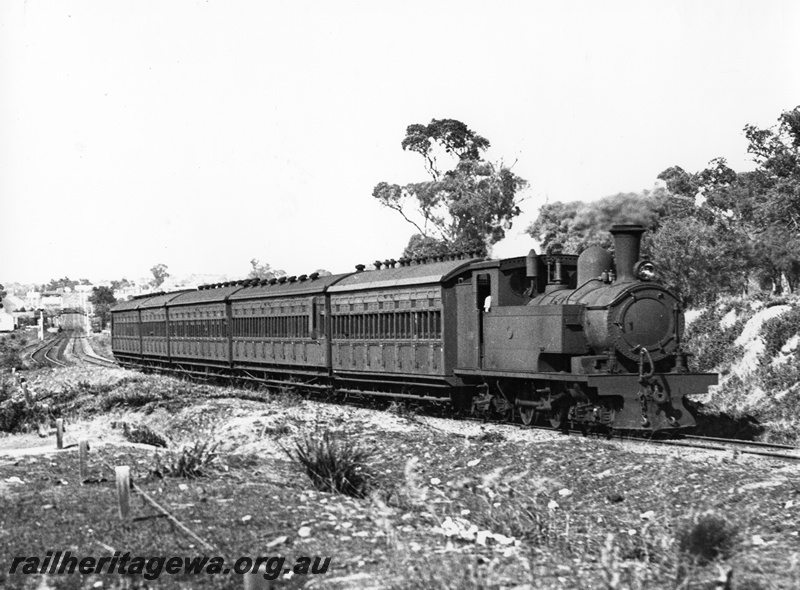P10267
N class steam loco hauling a train of five side loading suburban carriages, departing Karrakatta view along the train
